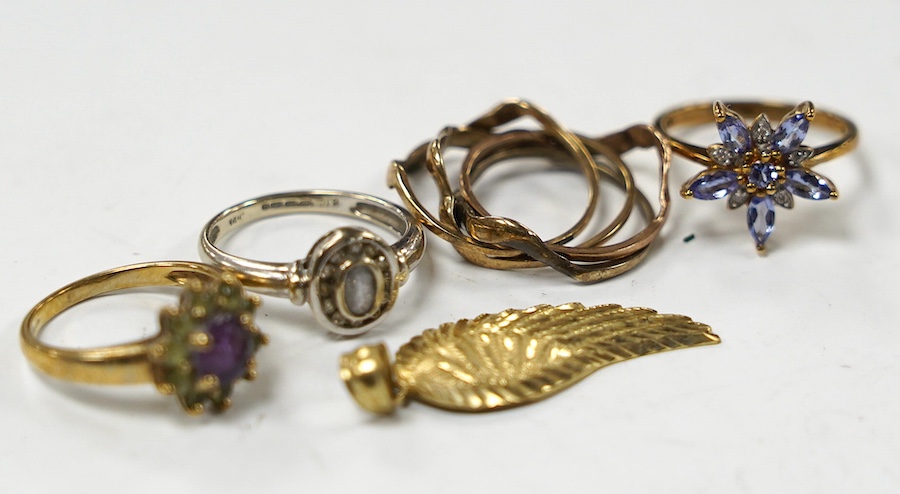 A modern 14k and gem set cluster ring, size L, gross weight 2.5 grams, together with three assorted 9ct rings, including gem set and a 9k leaf pendant, gross weight 10.8 grams. Condition - poor to fair
